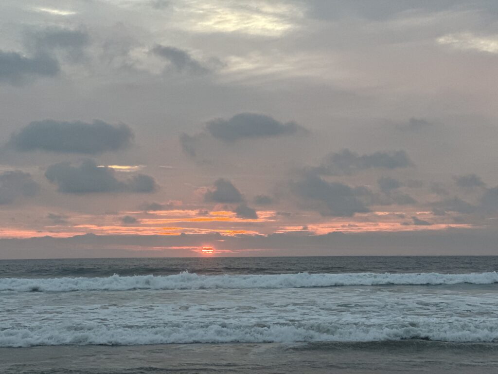 Calm ocean waves at golden sunset